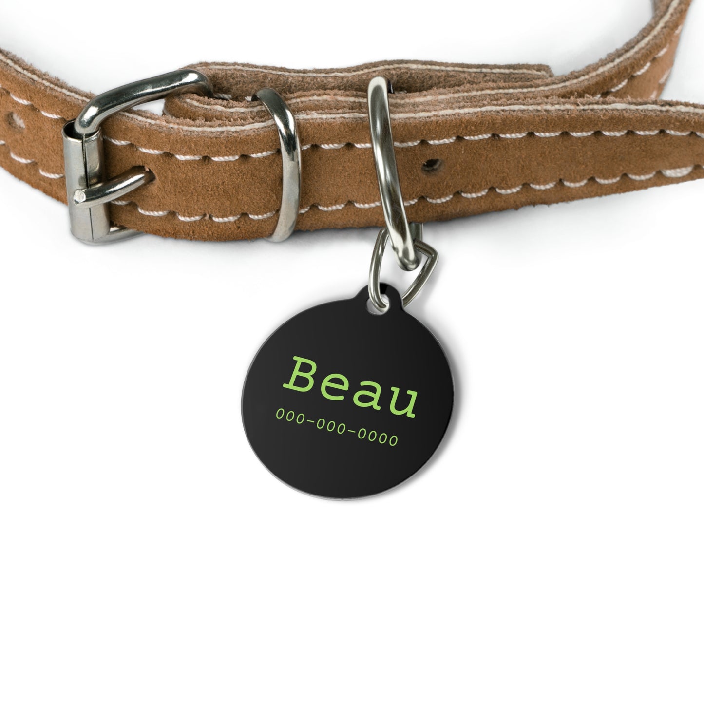 Personalized black and green pet ID tag with engraved details, designed for pets to wear as identification.