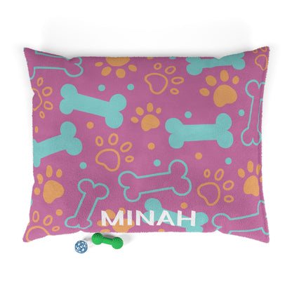 Pink personalized pet bed with bone pattern, soft fabric, designed for small dogs or cats, by Printify.