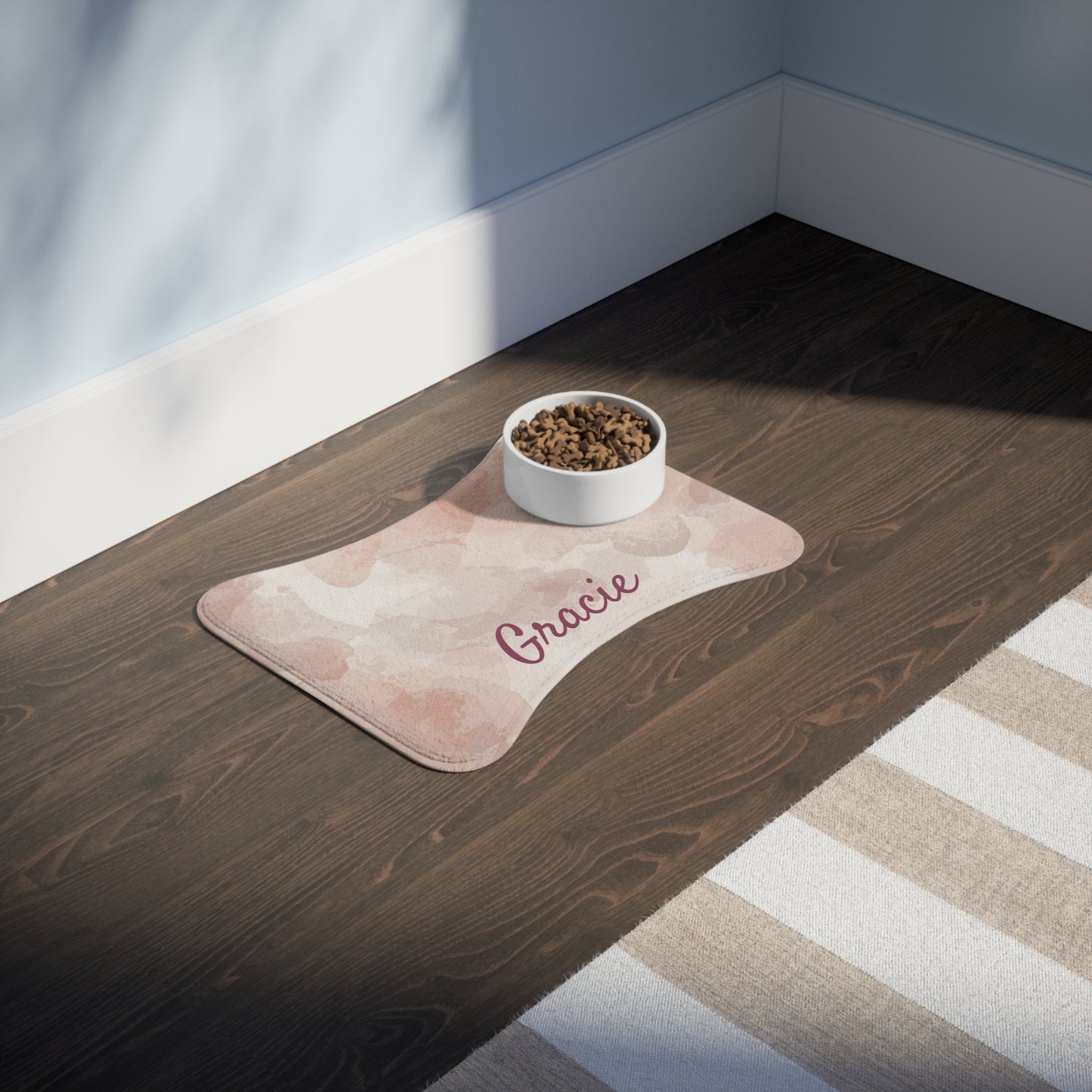 Personalized pink watercolor pet feeding mat featuring custom pet name, ideal for protecting floors during feeding.