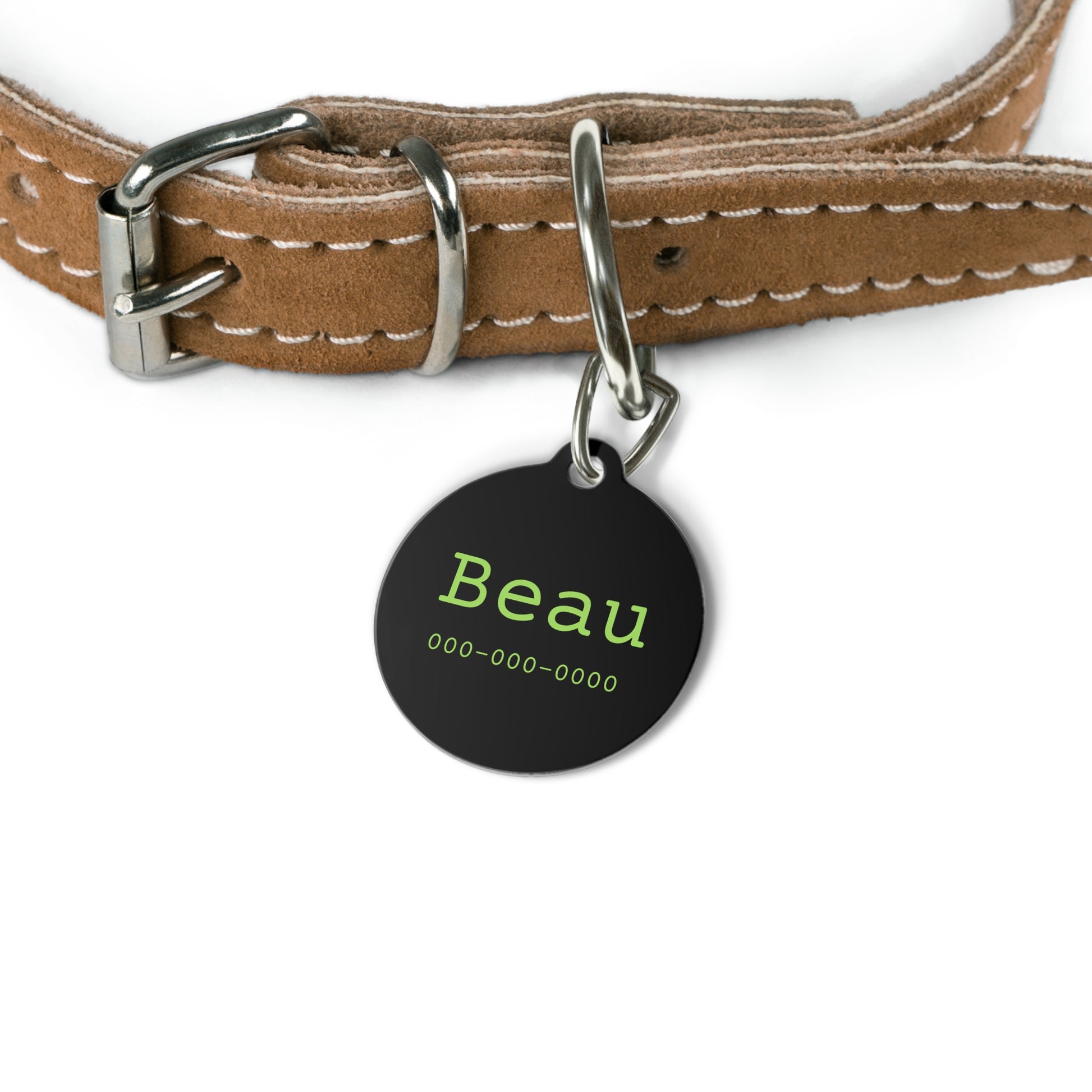 Personalized black and green pet ID tag with engraved details, designed for pets to wear as identification.