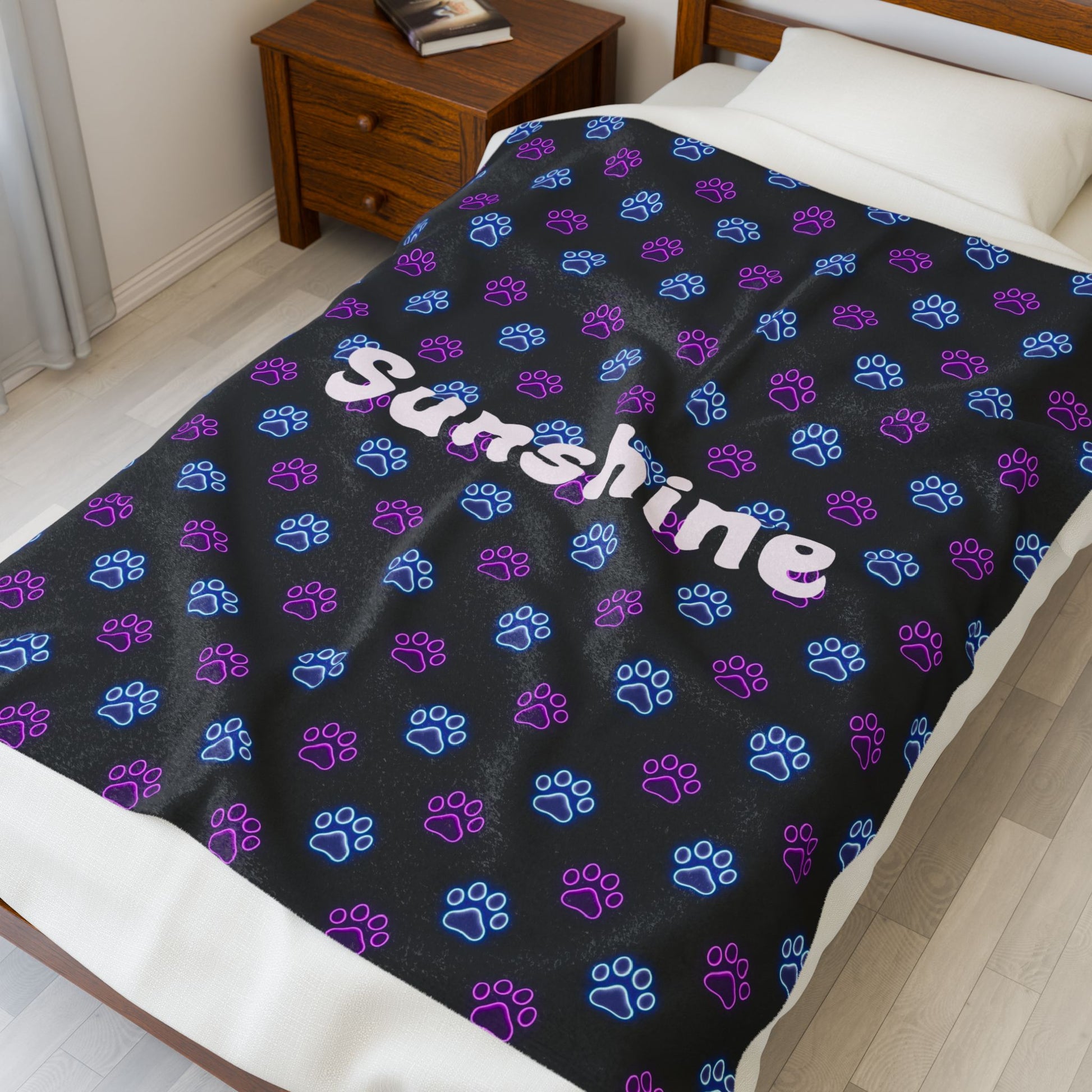 Soft personalized plush blanket with all-over neon paw print design, perfect for cozy comfort and custom gift-giving.